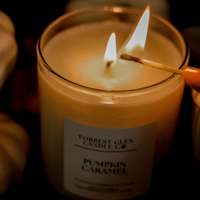 match lighting a soy wax candle in the fragrance pumpkin caramel  with fall decor pumpkins in the background