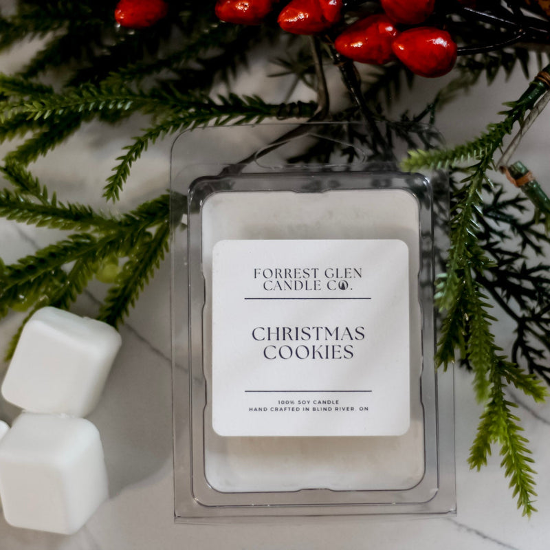 Forrest Glen Candle Co Christmas Cookies wax melt  with greenery and wax cubes on a marble surface