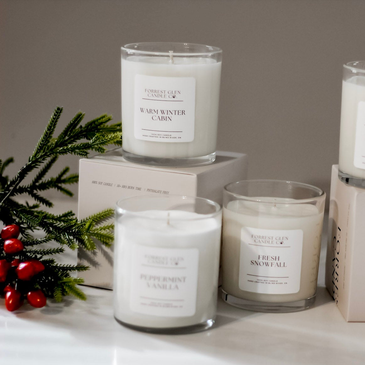 Set of candles with labels and boxes on a white surface