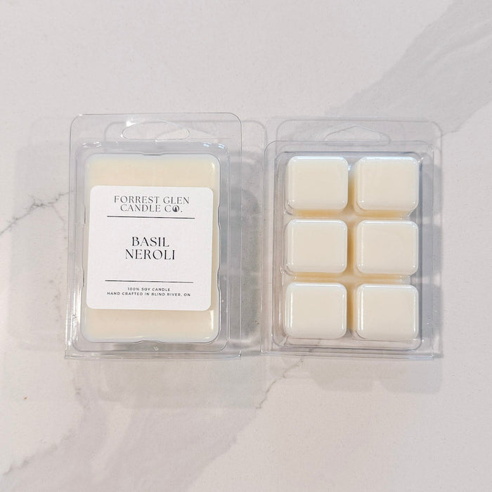 Two packages of wax melts labeled 'Basil Neroli' on a white surface.
