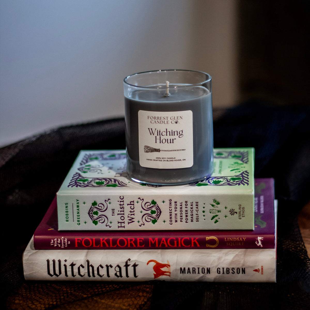Witching Hour black candle on top of magic books