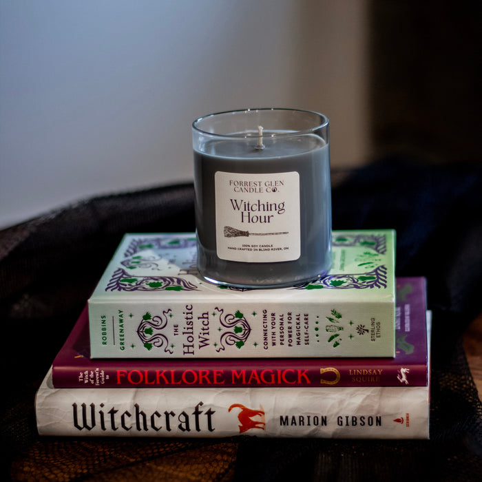 Witching Hour black candle on top of magic books